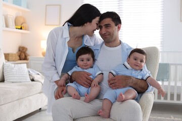 Fototapeta premium Happy family. Parents with their twin babies at home