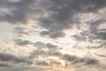 Dramatic Evening Sky with Sun Rays Breaking Through Dark Clouds