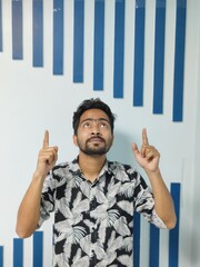 portrait of a young man standing in front of a wall
