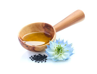 Black cumin seeds and oil with nigella sativa flower on white background