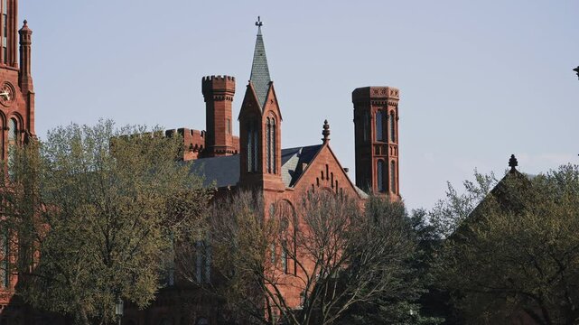 Red Brick Smithsonian Castle with Multiple Towers in Spring Light