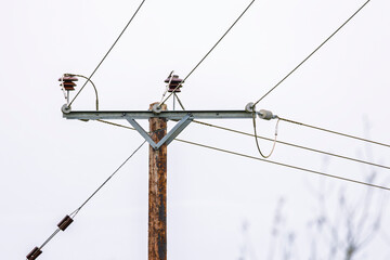 Electrical Transmission Power Poles with Wires and Insulators with blue sky and clouds