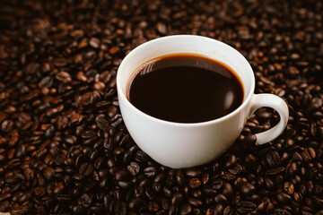 Close-up of roasted brown coffee beans falling against white background, showcasing texture, aroma, freshness, and energy for a morning brew.