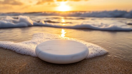 White disc-shaped object on the beach at sunrise.