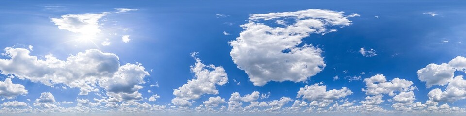 Spherical panorama of blue sky, a lot of cumulus clouds and sun shining 