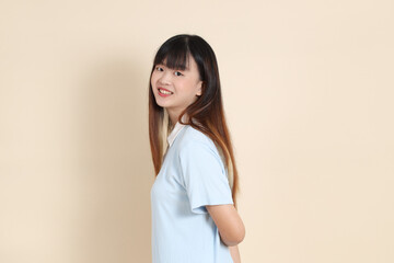 Obraz premium 20s Asian Woman in Light Blue Shirt and White Shorts