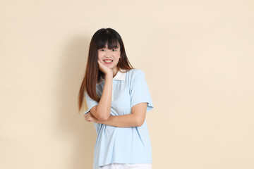 Obraz premium 20s Asian Woman in Light Blue Shirt and White Shorts