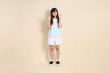 20s Asian Woman in Light Blue Shirt and White Shorts