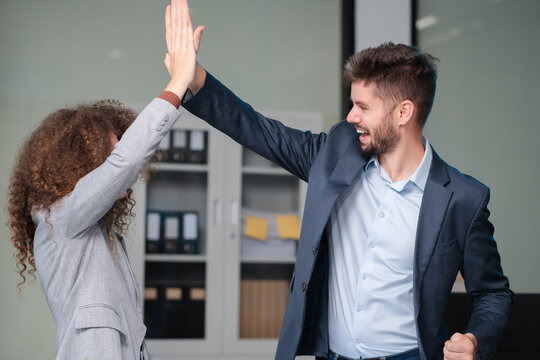 Happy creative business people are motivated, giving high five and celebration successful deal. Cooperation Meeting Partnership Career growth Team building Successful business. - Powered by Adobe
