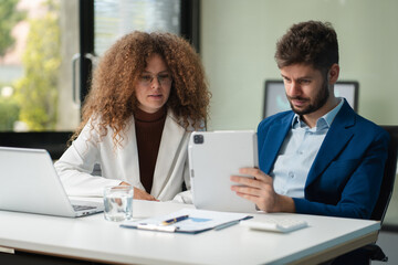 Diverse professionals collaborate on project analysis with financial graphs. Strategic teamwork and...