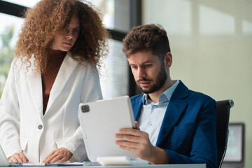 Diverse professionals collaborate on project analysis with financial graphs. Strategic teamwork and...