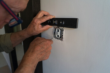 Elderly man using tools for home improvement projects