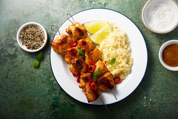 Chicken skewers with couscous and lime