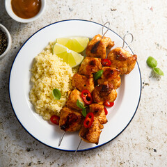 Chicken skewers with couscous and lime