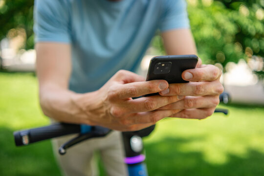 Man using smartphone while on electric scooter