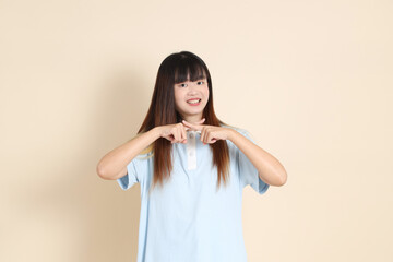 20s Asian Woman in Light Blue Shirt and White Shorts