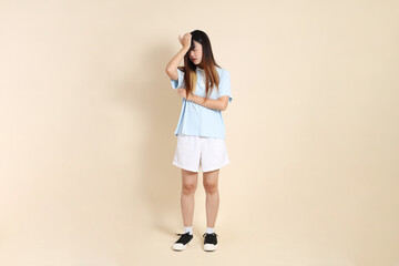 20s Asian Woman in Light Blue Shirt and White Shorts