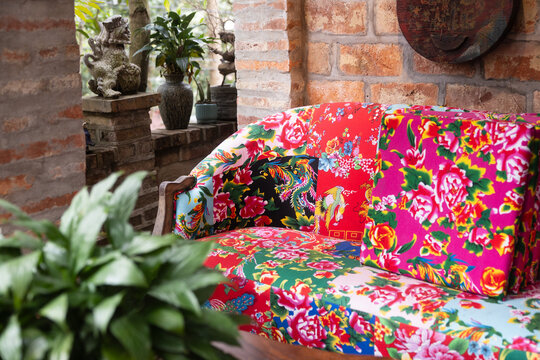 Vibrant floral sofa in a traditional Vietnamese setting
