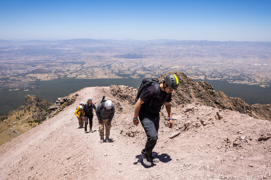 Climbers ascending a rugged mountain trail adventure