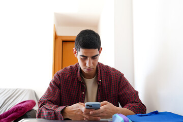 Young man engaged in daily smartphone routine