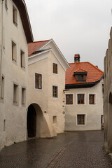 Narrow cobblestone street with historic European buildings in a medieval town, South Tyrol, Italy