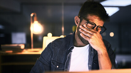 Tired, overworked and man with laptop, night or web designer with color sensitivity, sore or...