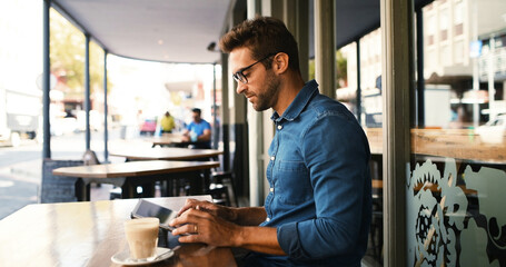 Customer, man and typing on tablet at cafe for online research, coffee break and remote work. Freelancer, person and scroll on digital app at bistro for networking, email response and check schedule