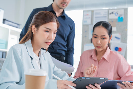 diverse team of business professionals actively engages in a strategic meeting focused on financial planning, goal alignment, and agile execution. With open laptops, financial reports graph chart 