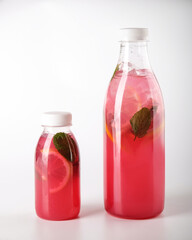 Enjoy a Refreshing Pink Beverage Served in Stylish Glass Bottles