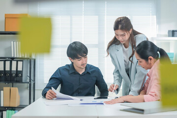 diverse group of business professionals gathers in a modern office for a strategic brainstorming...