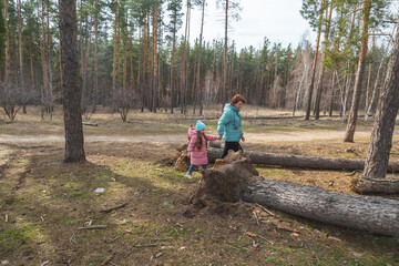 grandmother with granddaughter walking and playing in nature in the forest