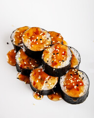 Delicious Sushi Rolls Beautifully Topped with Flavorful Sauce and Crunchy