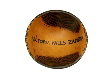 A traditional African hand-carved wooden bowl from Victoria Falls Zambia isolated against a white background