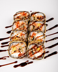 Savor these Delicious Sushi Rolls, artfully crafted with Drizzled Sauce