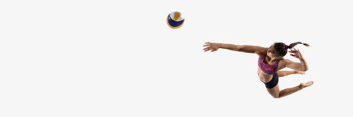 Banner. Aerial view of female athlete reaching to spike volleyball in air against white studio...