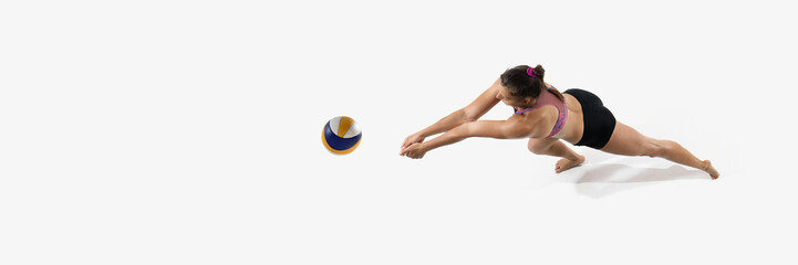 Banner. Top view of female player with arms extended hitting volleyball against white studio background with negative space to insert text. Concept of sport technique, athletic focus, ball control.
