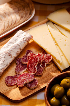 Catalan fuet and cheese on a wooden platter