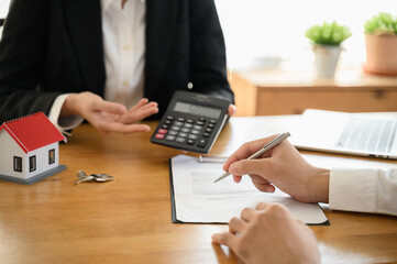 Real estate Business concept : Close up customer hand signing rental contract agreement document...