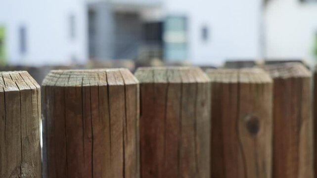 Close up selective focus view of a rustic round mounted wooden boundary wall
