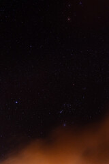Starry night sky with drifting clouds and cosmic atmosphere

