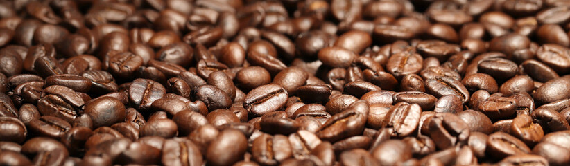 Coffee texture of fresh roasted beans close up. Food photo for backdrops or recipes.