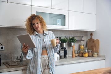 Simple living. Young woman morning routine in domestic kitchen in her apartment with first coffee...