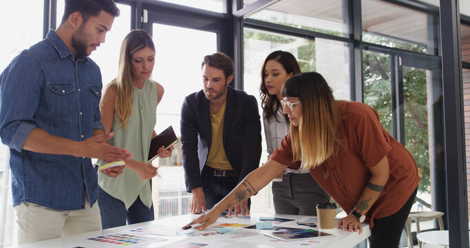 Office, business people and teamwork with decision for color swatch, creative agency and talking. Boardroom, women or men as graphic designer with palette for brainstorming, company branding or point - Powered by Adobe