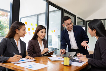 Group of business people working together with dashboard analysis and data management a meeting table in office.