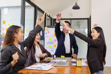 Group of Asian businesspeople Join hands and work together as a team in modern office, Business startup and company strategy planning concept.