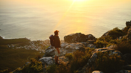 Hiking, sunrise or man with view of mountain for travel adventure, sightseeing or explore ocean. Tourist, back or person with backpack for trekking break, backpacker journey or scenery at destination