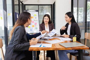 Group of Asian business working plan analysis project brainstorm in modern office, Asian businesspeople team working together, Business startup and company strategy planning concept.
