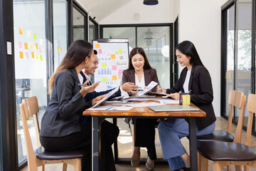 Group of Asian business working plan analysis project brainstorm in modern office, Asian businesspeople team working together, Business startup and company strategy planning concept.
