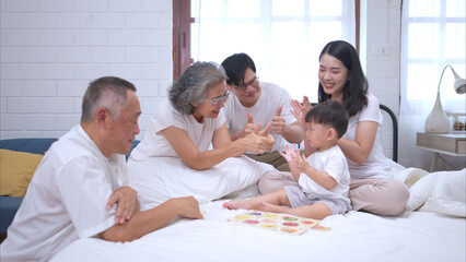 Fototapeta premium Before putting the kids to bed, parents, grandparents, and kid unwind and play