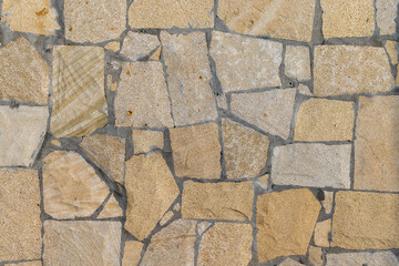 A high-resolution image of a seamless textured stone wall, photo texture